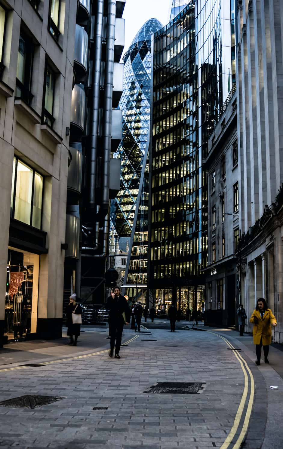 A central London street with the Gherkin the the background